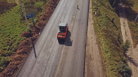 aerial view on the road roller working on the new road construction site. repair of the road in the city
