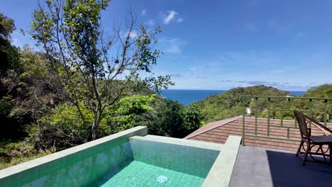 serene hillside villa on koh tao, thailand, featuring a tranquil pool and stunning ocean views. perfect for a peaceful getaway amidst lush greenery and azure waters under clear blue skies.