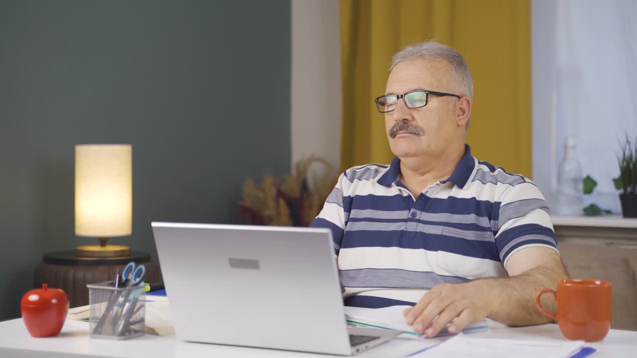 Home office worker old man working with concentration.