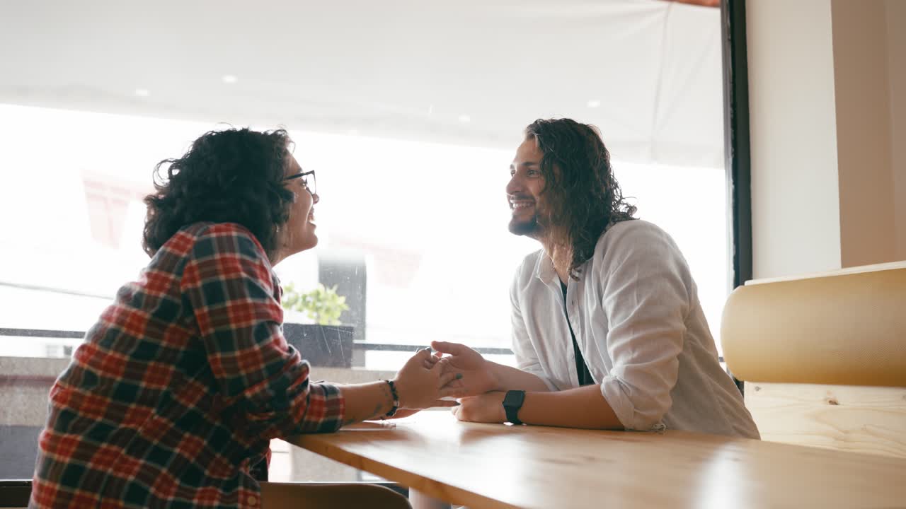 Couple Enjoying Conversation at a Cafe