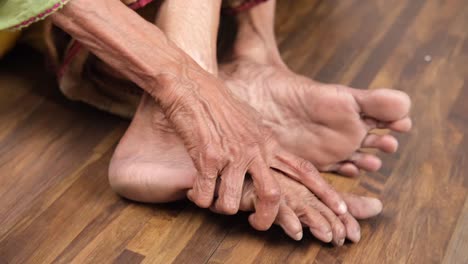 elderly person massaging their feet