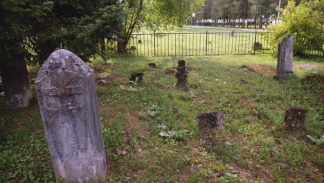 a panning view over the tombstones of an old graveyard near the town