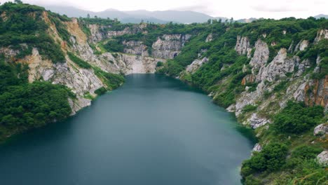 the old closed rock quarry a natural tourist attraction with a large blue pond is an interesting point in thailand