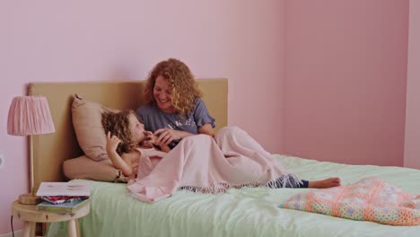 mother and daughter bonding on bed