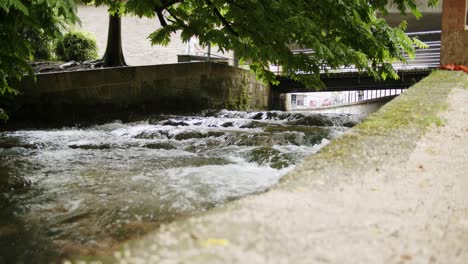 Wide-shot-of-a-small-river-within-walls-in-a-town