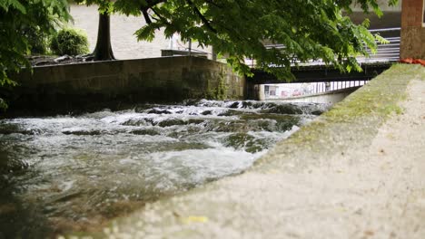 wide shot of a small river within walls in a town