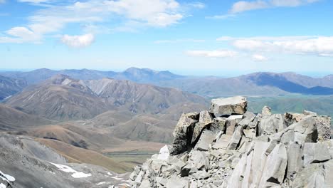 Stacked-up-scree-on-a-mountain-summit-in-sunshine