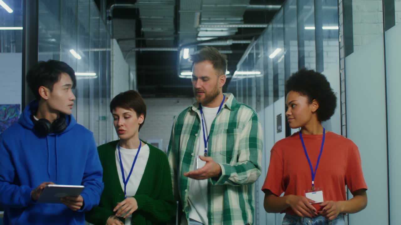 A group of entrepreneurs walk along the office center, talking among themselves
