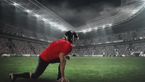 american football player kneeling for defence