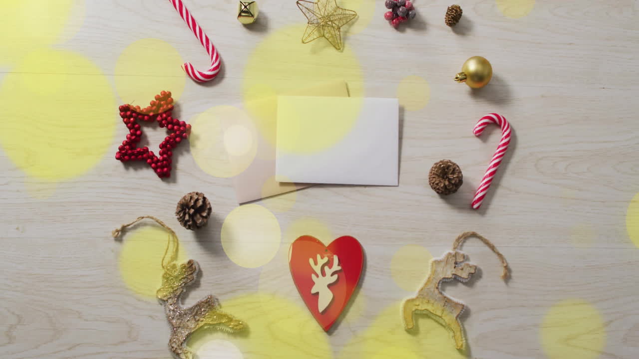 Animation of light spots over christmas decorations and cards