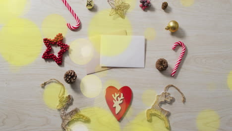 animation of light spots over christmas decorations and cards