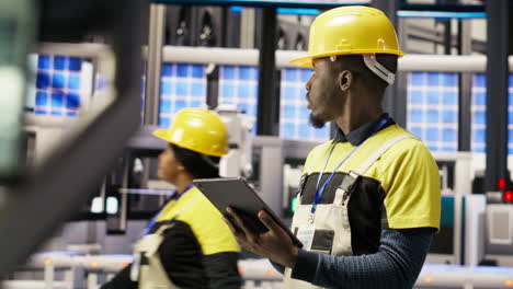 vertical video smart factory specialist testing automated systems, monitoring operations