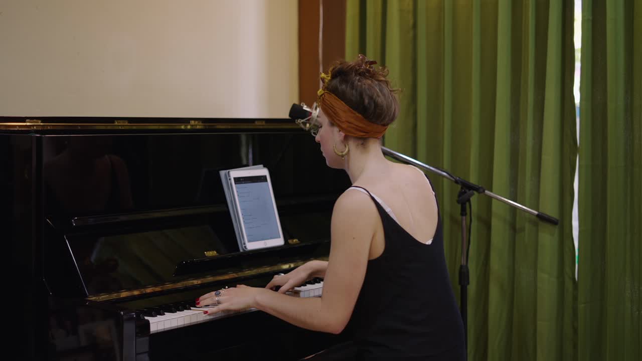 Woman Playing Piano with Microphone and Tablet