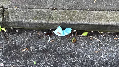 medical grade face mask abandoned in the street, pandemic waste, biohazard waste. 4k 60ffs