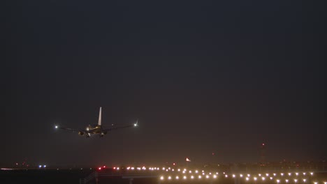 airplane descending and landing at night