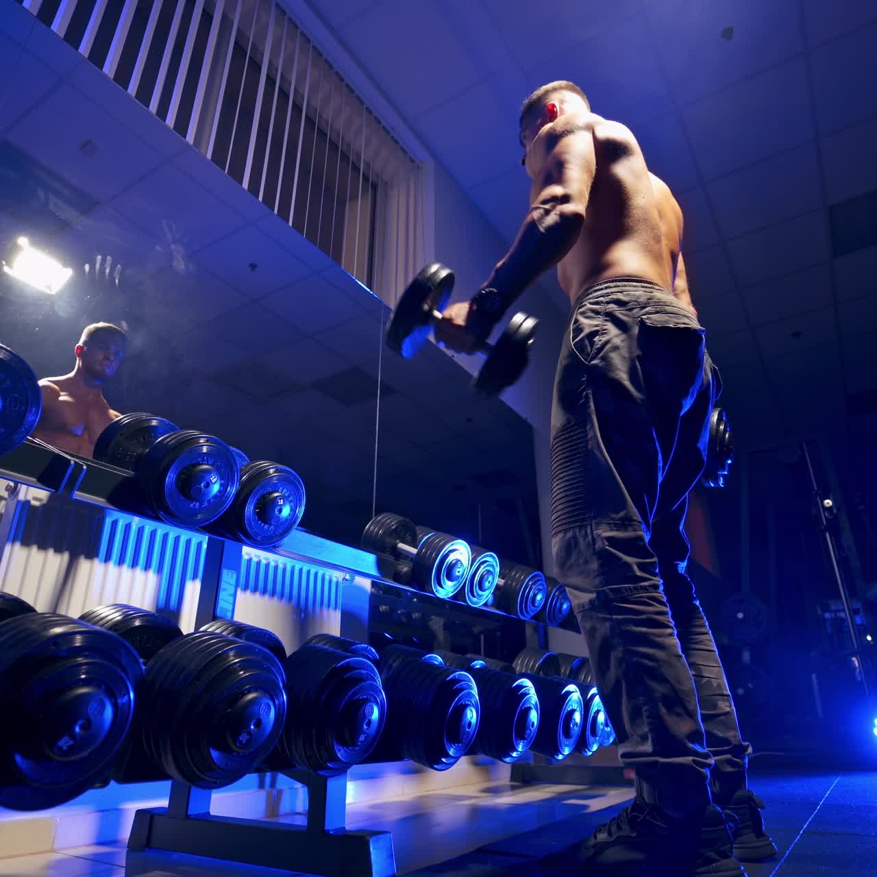 Fitness man with dumbbell in gym