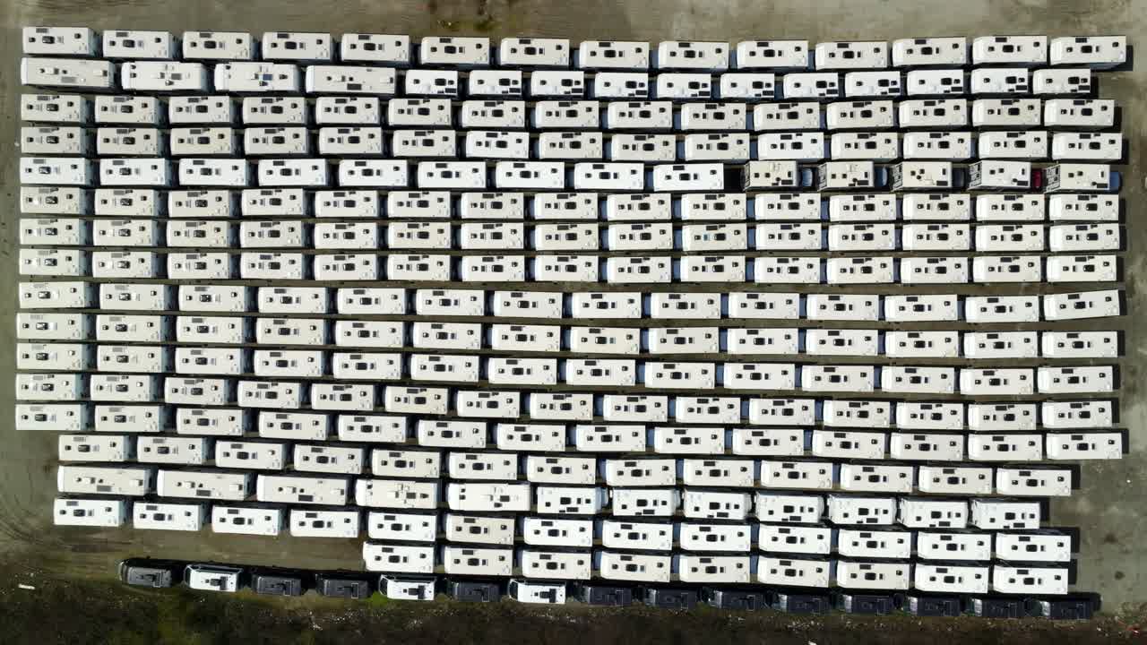Topdown View Of Asian-manufactured Recreational Vehicles At Storage Lot Of Industrial Warehouse In Richmond, Canada. aerial shot