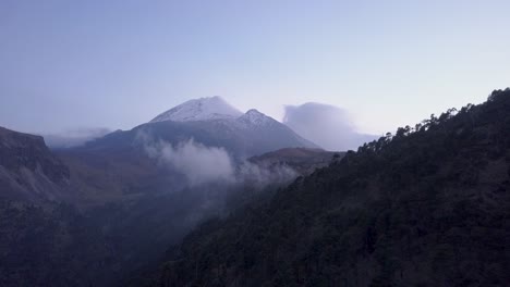 drone footage of pico de orizaba, the third tallest peak in north america, located in mexico. smooth flying towards the mountain near sunset