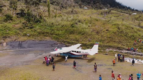 Aerial-footage-of-a-small-aircraft-on-a-mountain-runway-in-the-jungles-of-Papua,-Indonesia