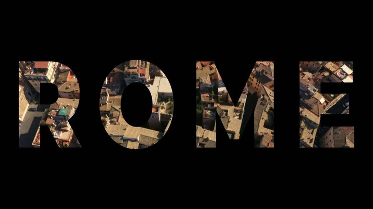 Aerial Drone Shot Of City Buildings In Italy Overlaid With Graphic Spelling Out Rome