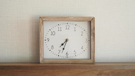 wooden square wall clock on shelf