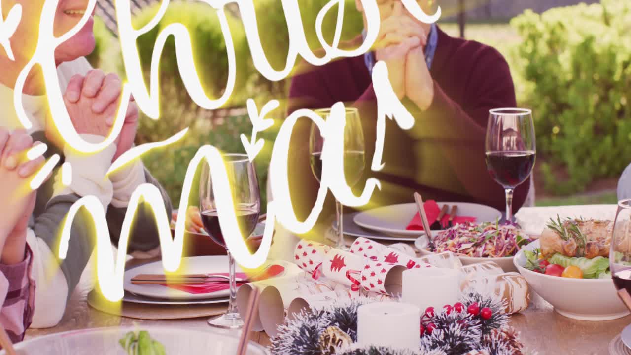 Animation of christmas greetings text over caucasian family at christmas table