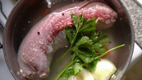 Cooking-Rolled-Matambre-In-Salted-Water-With-Parsley,-Onions-And-Peppercorns