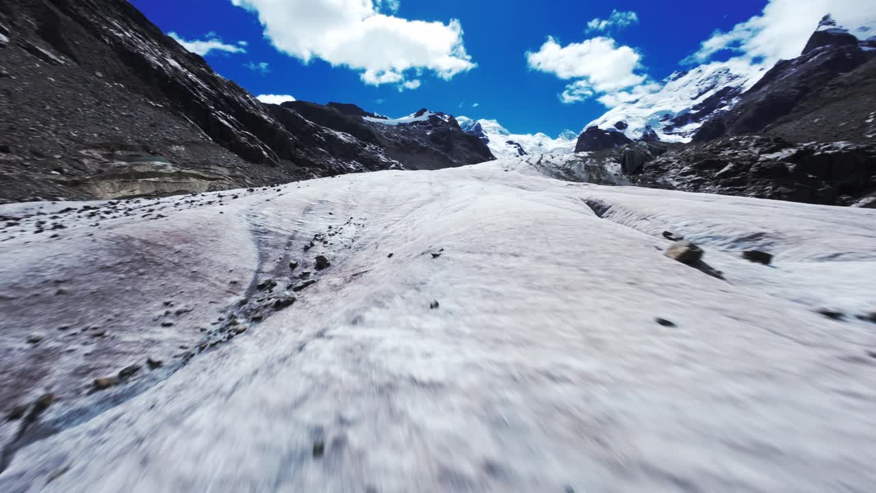 FPV drone glides over Swiss glaciers, capturing stunning mountain scenery