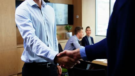 Executives-shaking-hands-in-office