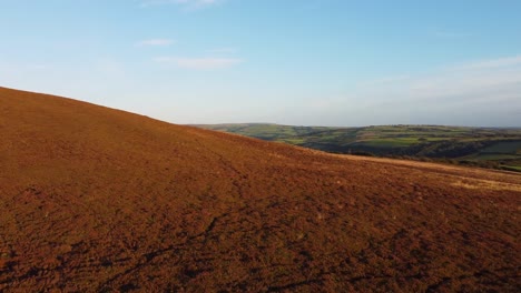 fast sunset aerial drone footage on moorland revealing rolling green hills in north devon uk 4k