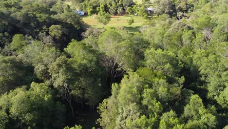 Aerial-drone-view-of-a-freshwater-stream-and-waterfall-inside-the-forest-in-Salto-Chávez,-Misiones,-Argentina