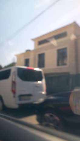 blurred street view with moving cars and buildings