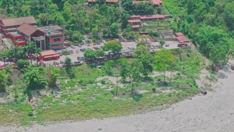 a cable car travels above a flowing river and lush green mountains, offering a stunning view of nature, elevation, and movement. perfect for themes of travel, exploration, and scenic transportation