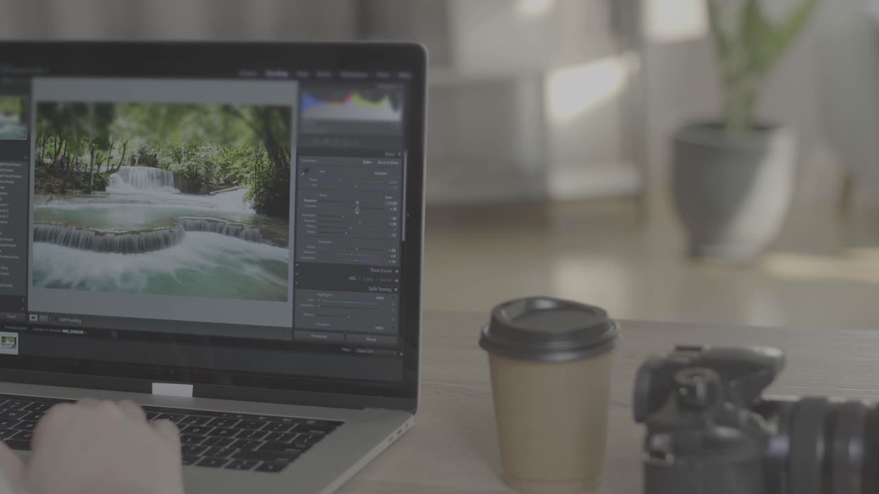 Man Works In Photo Editing App / Software On His Laptop Computer. Photo Editor Retouching Photos Of Beautiful Nature