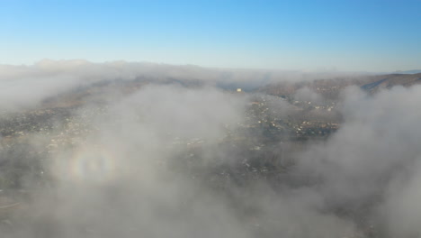 Aerial-view-of-low-fog-over-mountains-in-San-Diego-during-sunrise