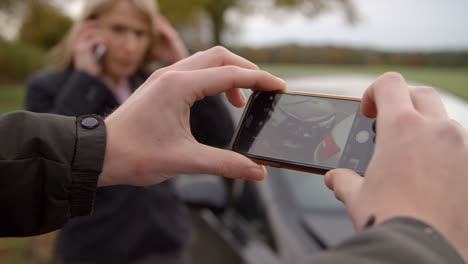 Man-Taking-Photo-Of-Car-Accident-On-Mobile-Phone