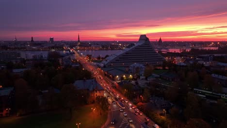 dramatic sunrise over cityscape, highlighting morning traffic flow, riga, latvia