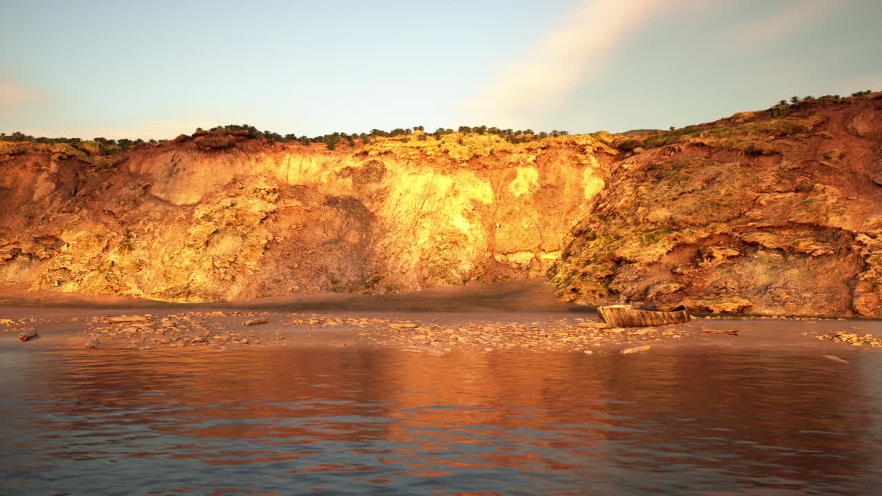 Textured rugged cliff in amber tones with flowing water foreground