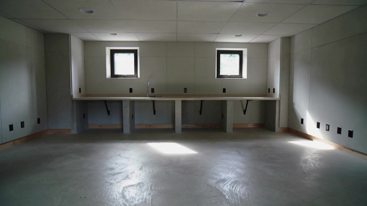 Fixed cam recording workbench with two windows in basement, clouds shifting sunlight patch