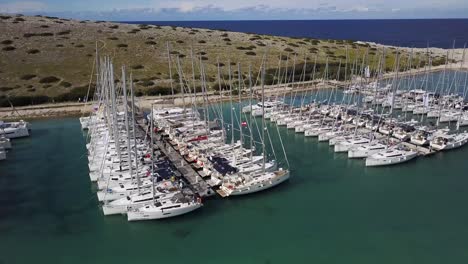 sailboats moored in marine piskera, kornati islands in croatia - aerial drone view