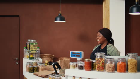 shopper choosing pasta and spices stored in jars