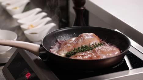 cooking chicken breast with onions and herbs
