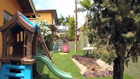 Suburban-backyard-with-kids-playhouse-on-a-windy-day