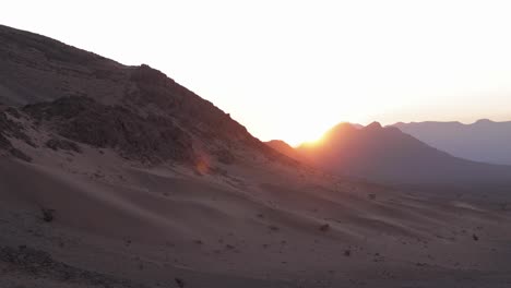time-lapse of a sahara desert sunrise, casting its first rays on the endless dunes