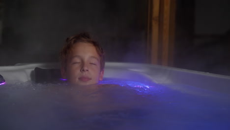 Boy-relaxing-in-outdoor-bathroom