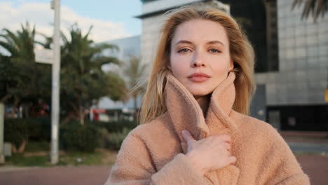 Blonde-woman-looking-at-the-camera-outdoors.