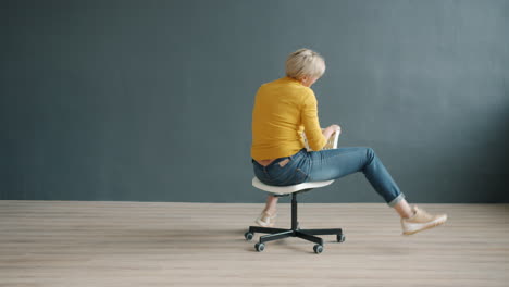 woman sitting on a chair, playing