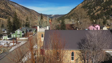 aerial orbit of a gothic design church in a small town in the united states - drone shot