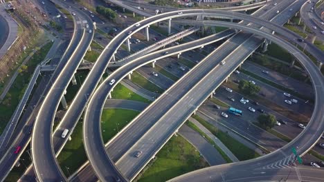 top down angle aerial drone view of elevated road and traffic junctions in chinese metropolis city chengdu during sunny day. modern construction design of traffic ways to avoid traffic jams, many cars