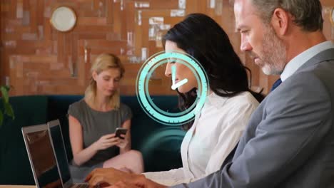 animation of clock ticking over diverse business people using laptop